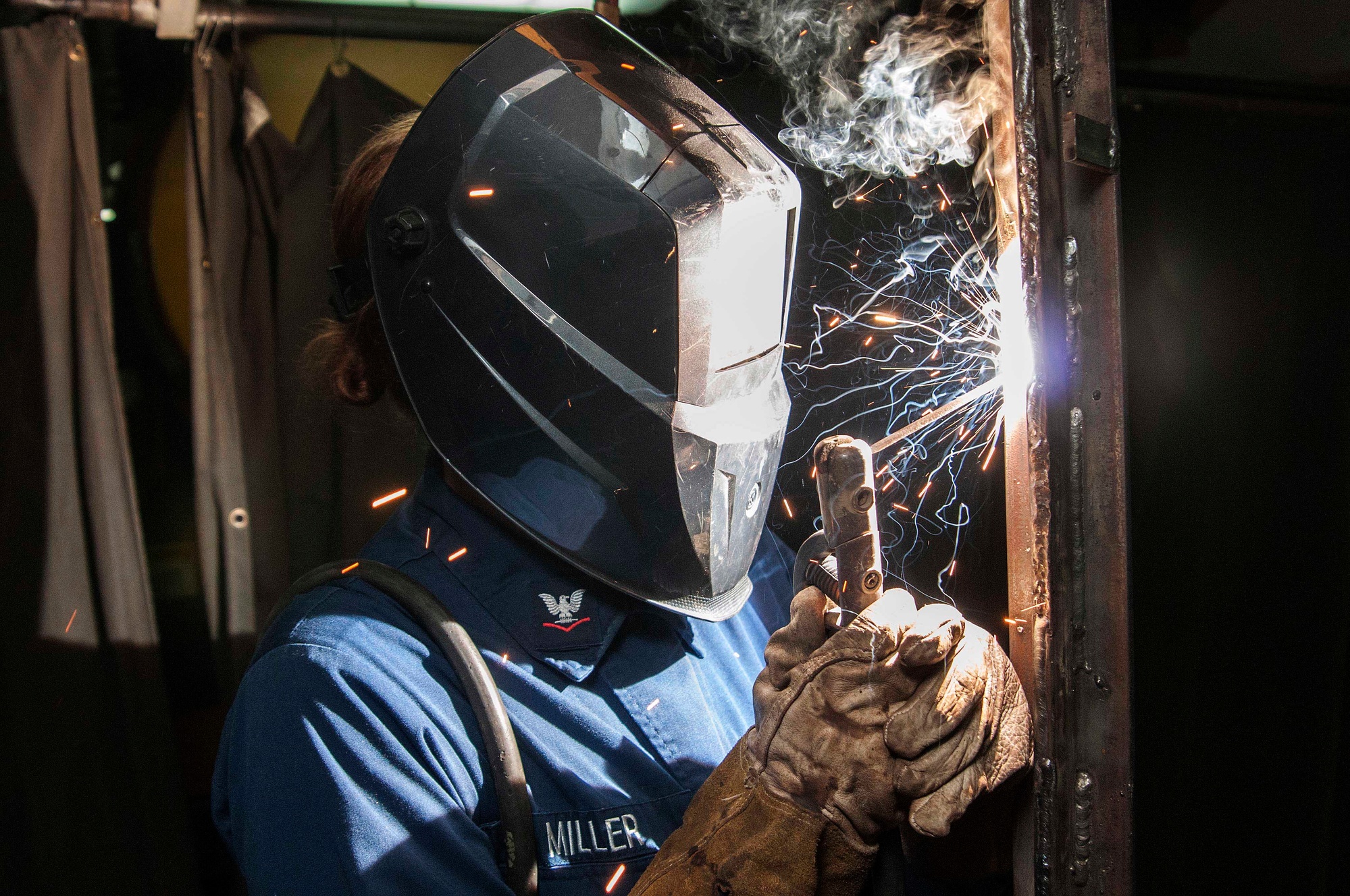 A Navy service member practicing advanced welding skills