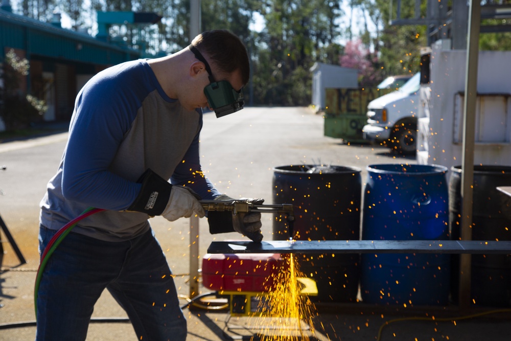 A transitioning service member completing hands-on metalwork training